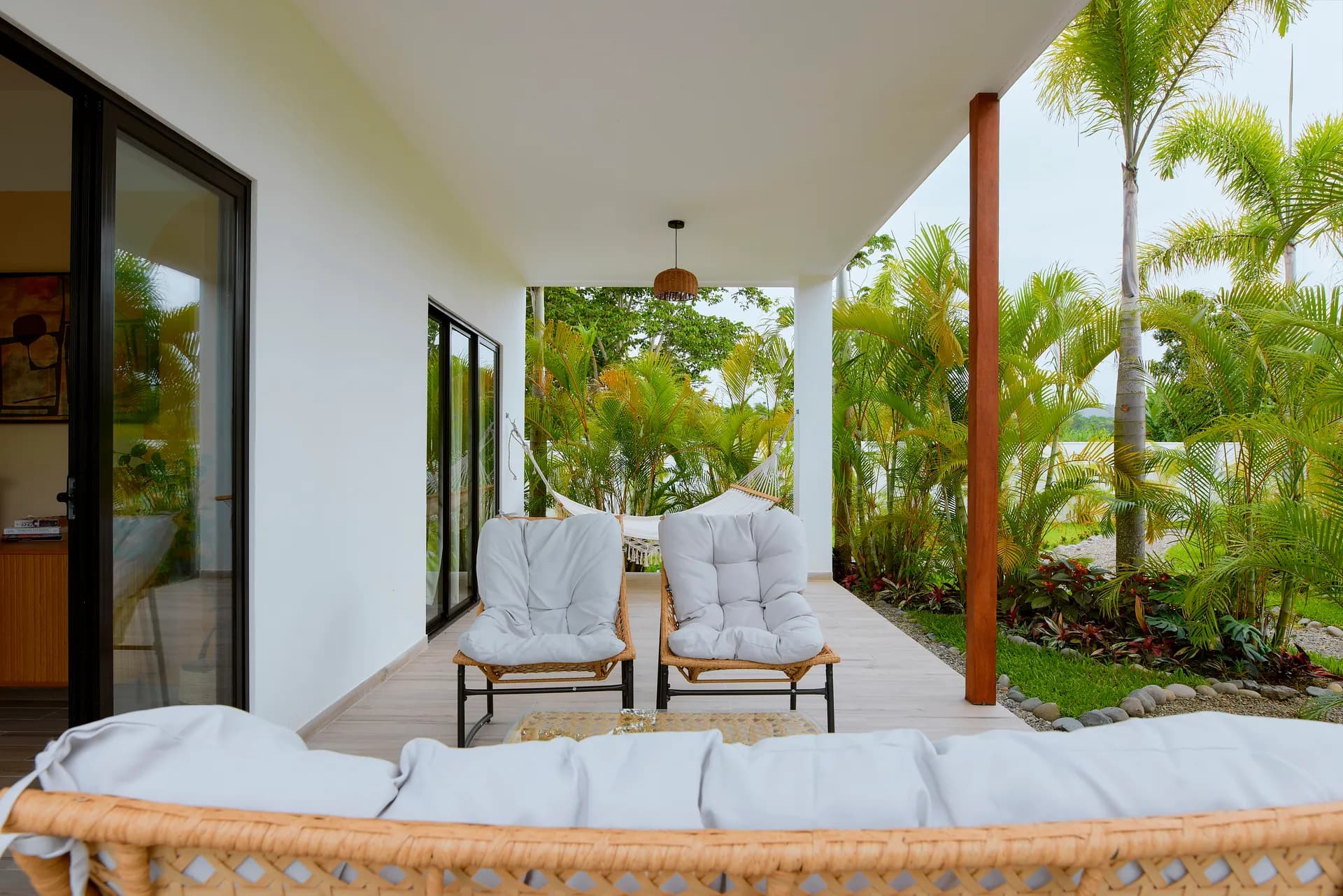 Terraza de la planta baja de Casa Gray con muebles de ratán